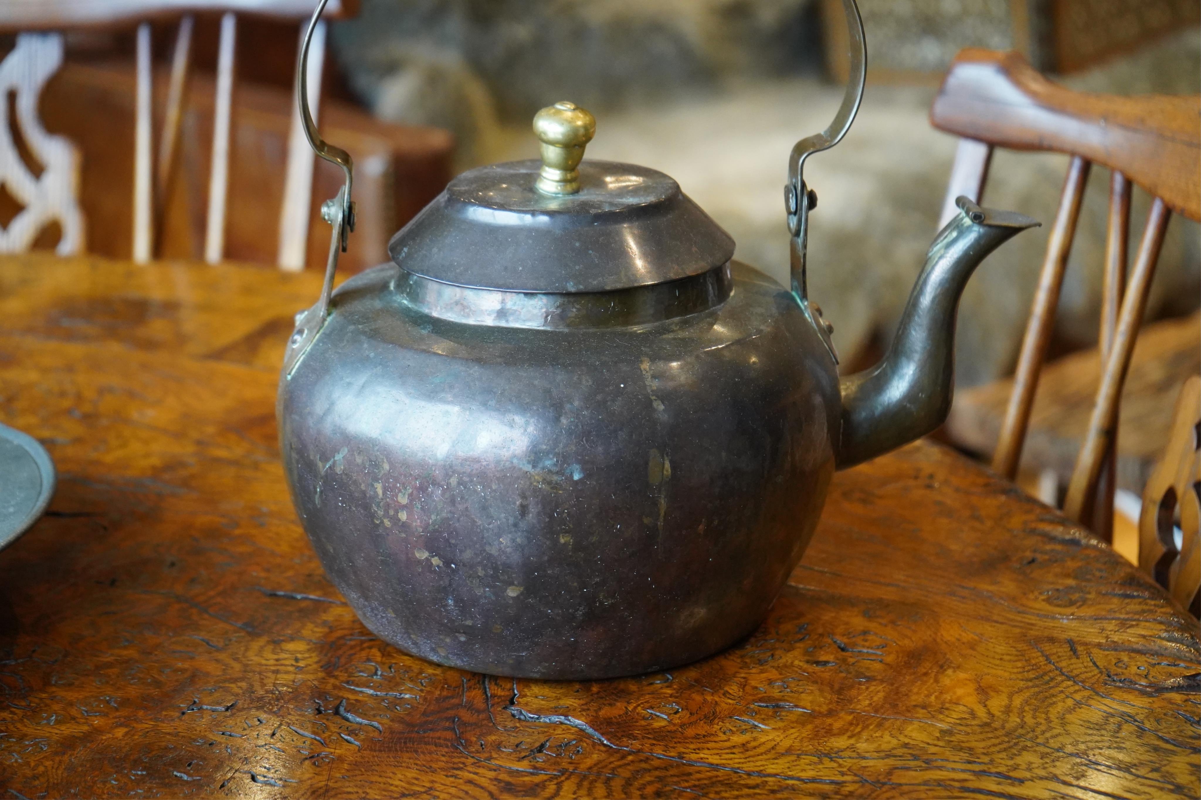 A Dutch copper kettle with brass knop, 34cm wide. Condition - fair